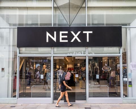 Next forecasts bigger profits after hot weather lifts sales