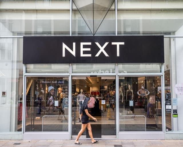 Next forecasts bigger profits after hot weather lifts sales