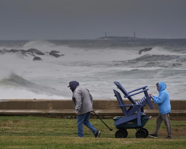 Power outages and flooded roads as major storm bears down on US north-east