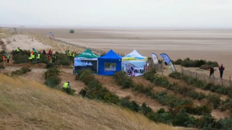 How discarded Christmas trees are being used to build dunes on a UK beach