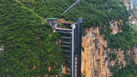 Children in China trekked 3 hours up and down an 800m cliff to school; two elevators and a cable car cut it to 30 minutes