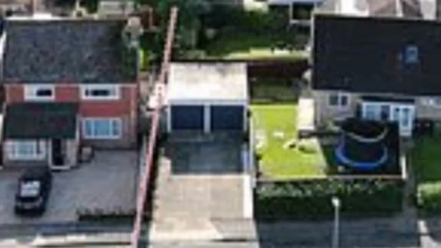 Priest caught on CCTV sprinkling holy water on disputed fence as fight with neighbour escalates